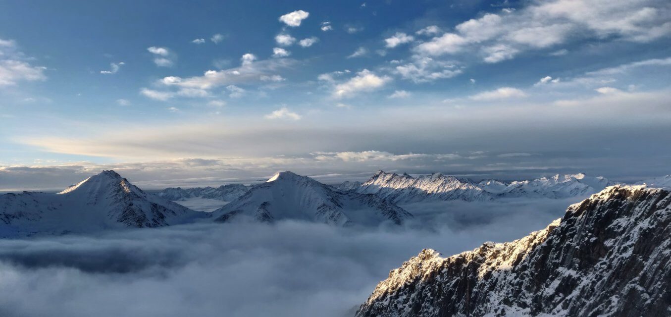 Snow-capped peaks rising above a sea of clouds at Mount Siguniang